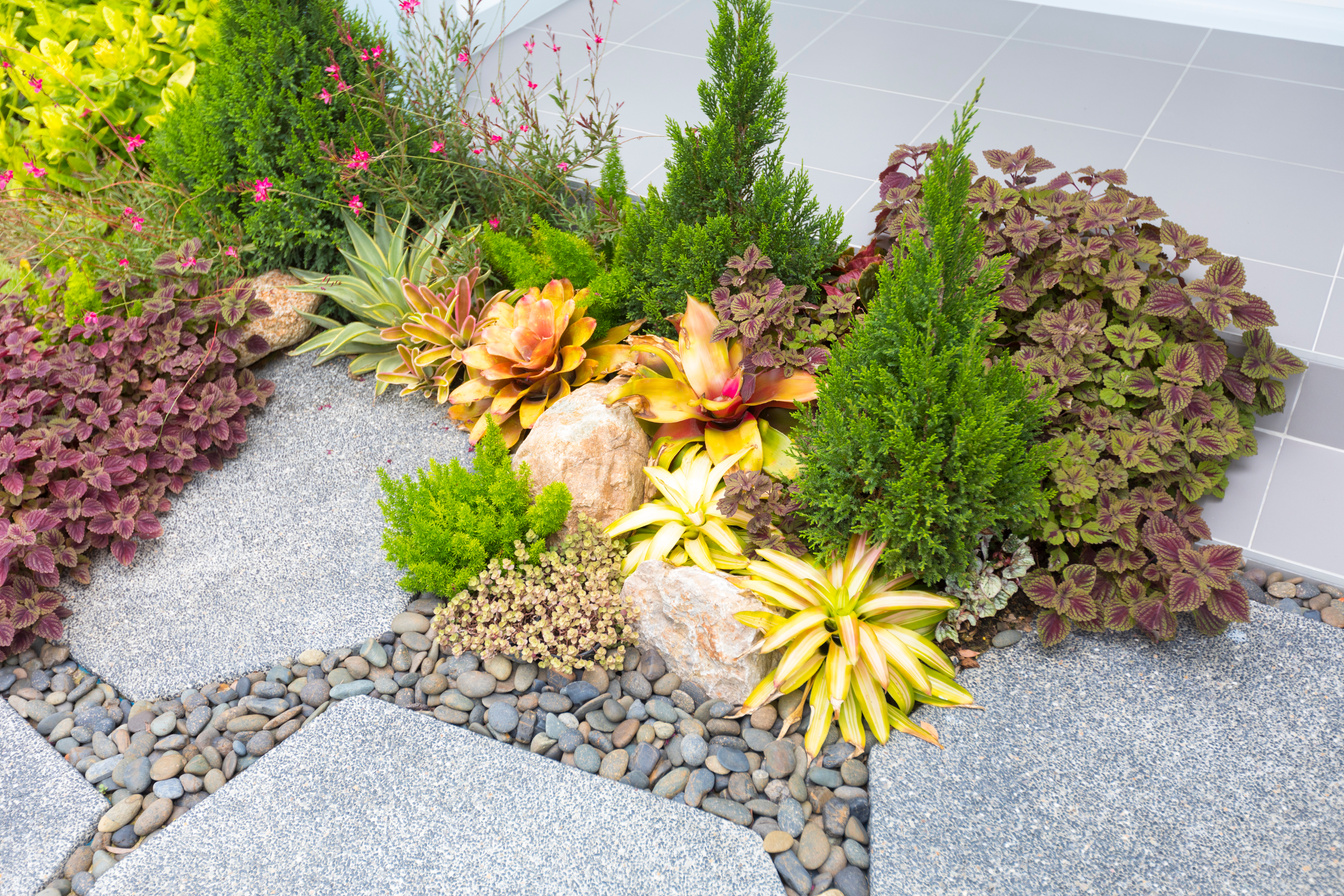 Natural stone landscaping in backyard in summer.
